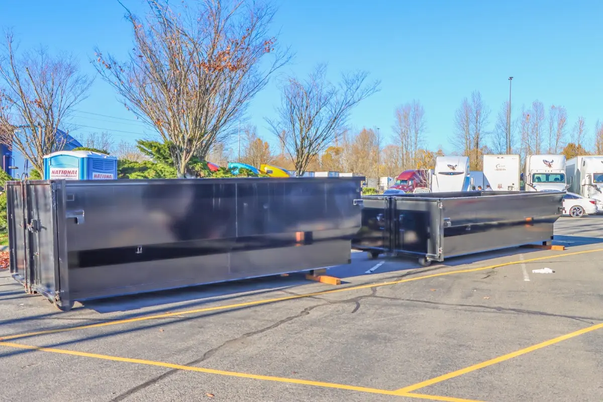 Professional dumpster rental service with roll-off container on residential driveway in Travilah
